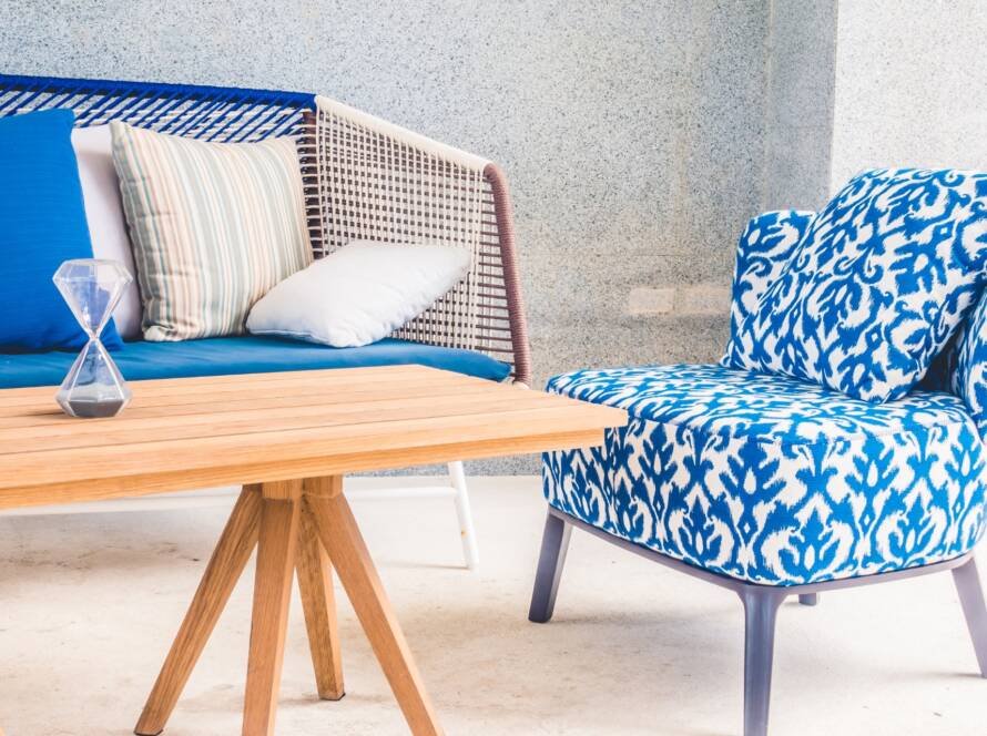 Luxury blue patterned accent chair with wooden coffee table and contemporary lounge seating