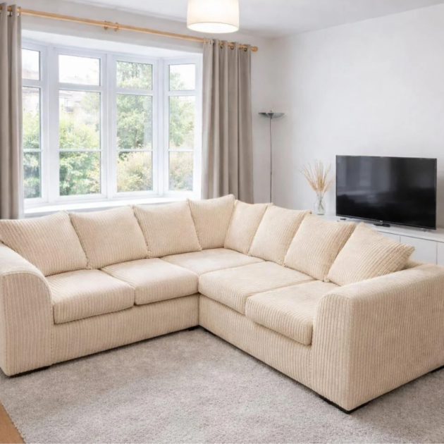 Cream jumbo cord 5-seater corner sofa with plush cushions in a bright contemporary living room.