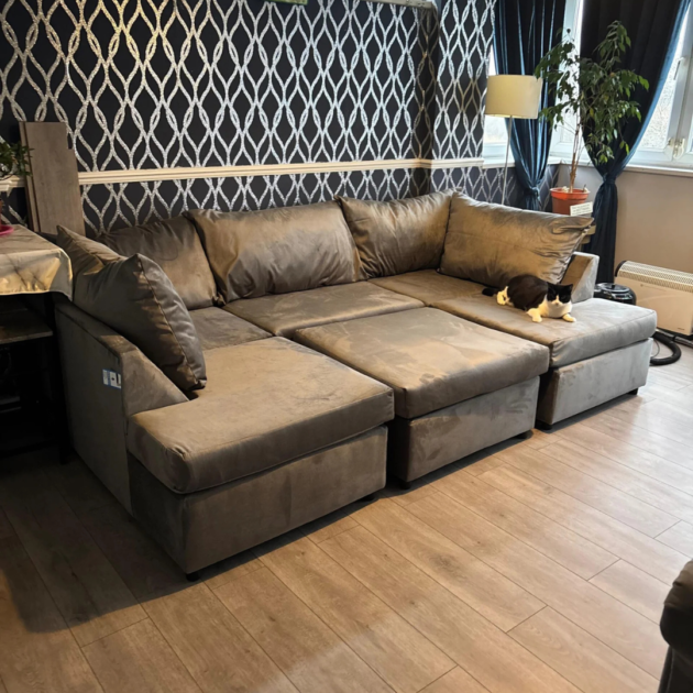 Grey U shape sofa with deep cushions and spacious seating in a modern living room.