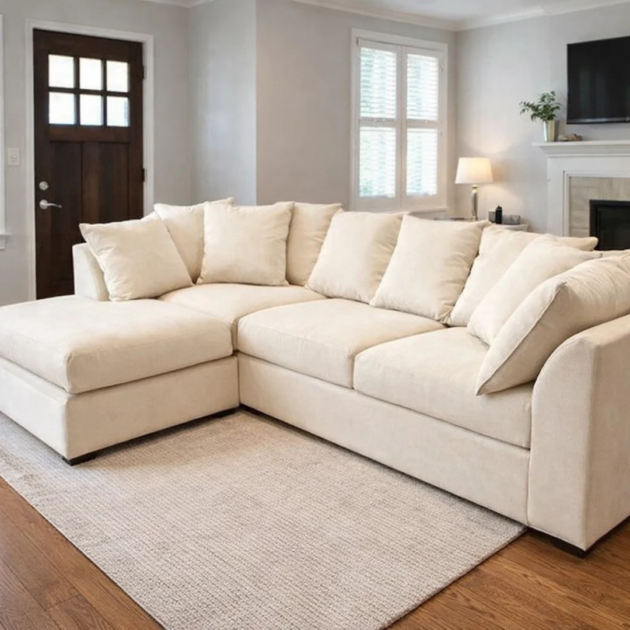 Modern 4 seater cream corner sofa with deep cushions and contemporary design in a stylish living room.