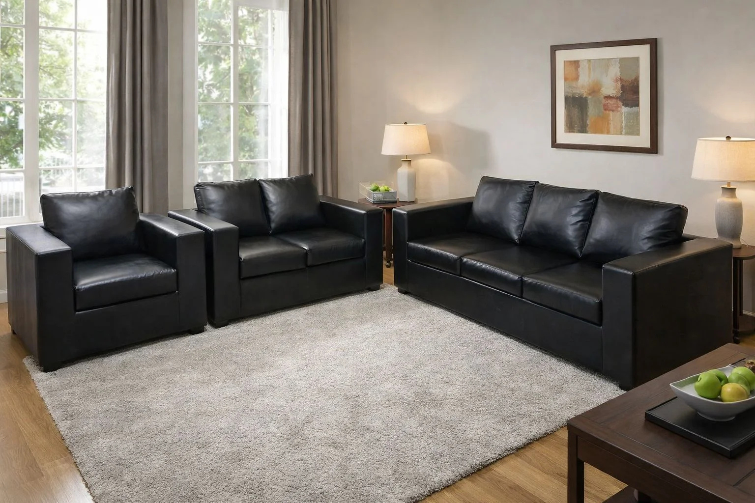 Modern black leather 3+2+1 sofa set with armchair, loveseat, and three-seater in a contemporary living room with soft grey rug and stylish décor.